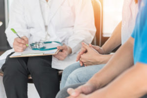 doctor delivering bad news to a couple