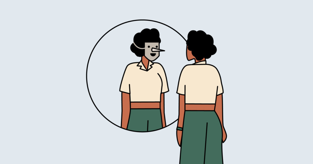 woman looking at masked self-image in mirror